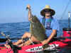 The "big juicy halibut pose" - Kevin "Yakslam" with the fish of the day