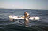 Jon Schwartz of Carlsbad, CA doing his best to hoist the 180+lb Marlin onto his kayak for a picture